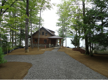 Custom landscaping and new driveway by Rossignol's Excavating.