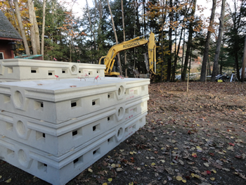 Heavy duty concrete septic system chambers waiting
to be installed by Rossignol's Excavating.